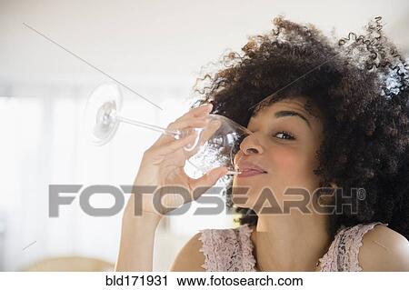Mixed race woman drinking glass of wine View Large Photo Image Stock Image - Mixed race woman drinking glass of wine. Fotosearch