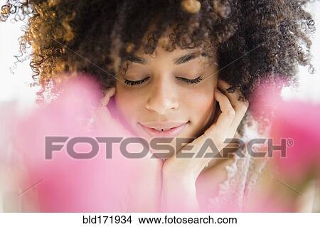 Mixed race woman resting chin in hands View Large Photo Image Picture - Mixed race woman resting chin in hands. Fotosearch