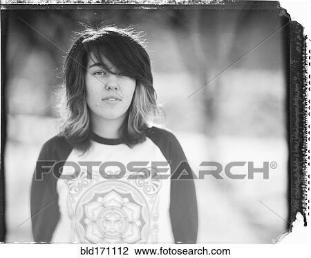 Stock Image - Mixed race woman standing outdoors. Fotosearch