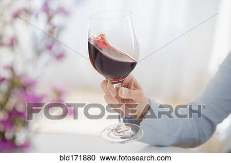 Mixed race woman swirling glass of wine View Large Photo Image Stock Image - Mixed race woman swirling glass of wine. Fotosearch