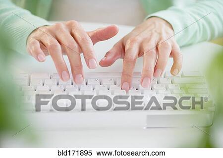 Mixed race woman typing on computer keyboard View Large Photo Image Stock Photography - Mixed race woman typing on computer keyboard. Fotosearch