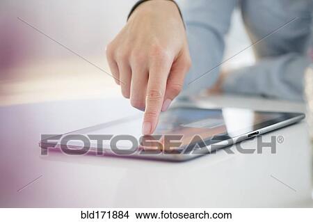 Mixed race woman using digital tablet View Large Photo Image Picture - Mixed race woman using digital tablet. Fotosearch