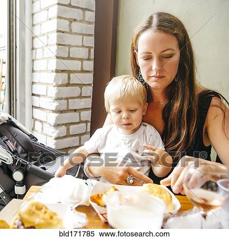 Mother and son eating in restaurant View Large Photo Image Stock Photography - Mother and son eating in restaurant. Fotosearch