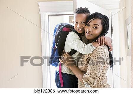 Mother and son hugging at door View Large Photo Image Stock Photography - Mother and son hugging at door. Fotosearch