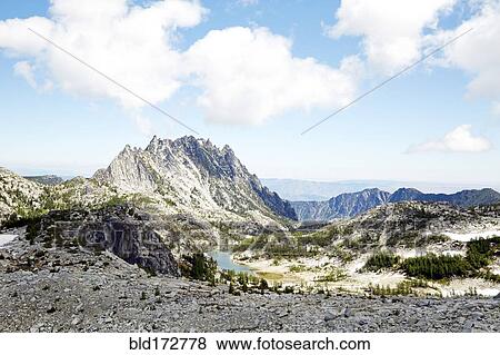Stock Photo - Mountains and fields in remote landscape. Fotosearch