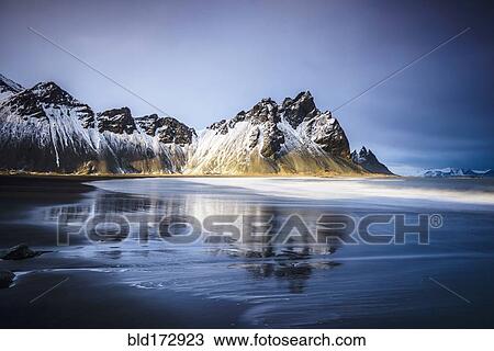 Ocean waves on beach under snowy mountains View Large Photo Image Stock Image - Ocean waves on beach under snowy mountains. Fotosearch