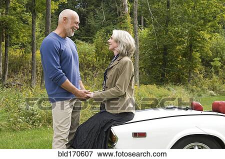 Older couple holding hands on convertible View Large Photo Image Stock Photo - Older couple holding hands on convertible. Fotosearch