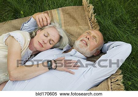 Older couple napping on picnic blanket View Large Photo Image Stock Photography - Older couple napping on picnic blanket. Fotosearch