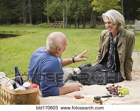 Older couple relaxing at picnic in park View Large Photo Image Stock Image - Older couple relaxing at picnic in park. Fotosearch