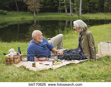 Older couple relaxing at picnic in park View Large Photo Image Stock Photograph - Older couple relaxing at picnic in park. Fotosearch