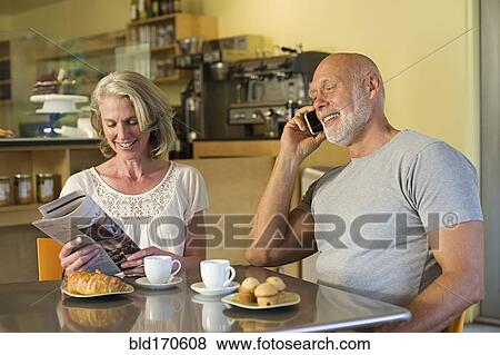 Stock Photo - Older couple relaxing in cafe. Fotosearch