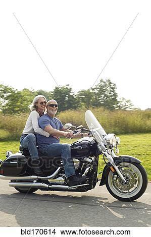 Picture - Older couple riding motorcycle. Fotosearch