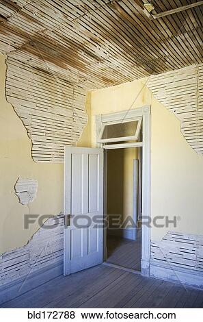 Stock Photo - Open door of dilapidated room. Fotosearch