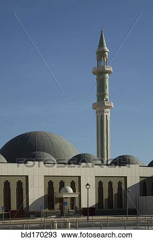 Stock Image - Ornate spire and dome building under blue sky. Fotosearch