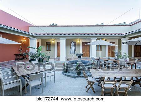 Patio tables in hotel courtyard View Large Photo Image Picture - Patio tables in hotel courtyard. Fotosearch