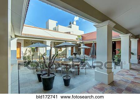 Patio tables in hotel courtyard View Large Photo Image Stock Image - Patio tables in hotel courtyard. Fotosearch