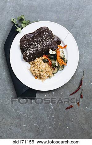 Stock Photograph - Plate of enchiladas with vegetables and rice. Fotosearch