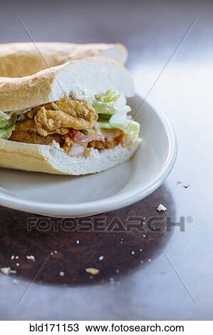 Po-boy sandwich on plate View Large Photo Image Stock Image - Po-boy sandwich on plate. Fotosearch