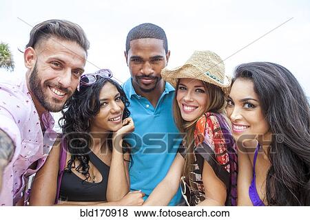 Stock Photo - Portrait of friends smiling outdoors. Fotosearch