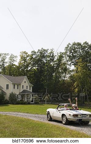 Rear view of older couple driving convertible View Large Photo Image Stock Photograph - Rear view of older couple driving convertible. Fotosearch