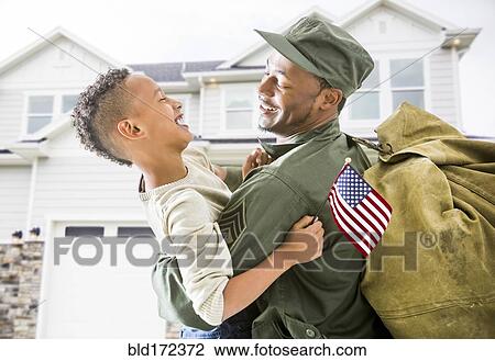 Returning soldier hugging patriotic son outside house View Large Photo Image Stock Image - Returning soldier hugging patriotic son outside house. Fotosearch