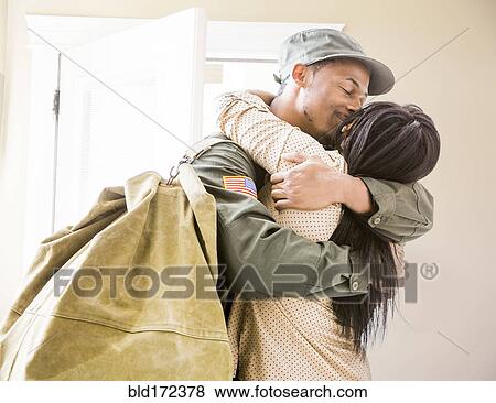 Returning soldier kissing wife in hallway View Large Photo Image Stock Photo - Returning soldier kissing wife in hallway. Fotosearch