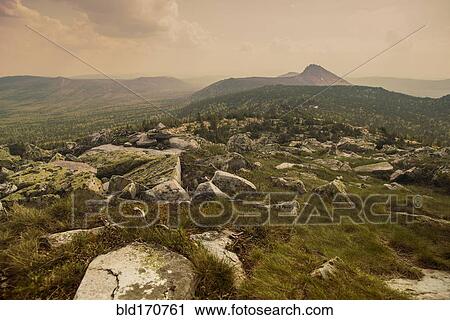 Stock Image - Rocky field in remote landscape. Fotosearch