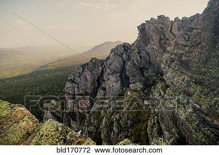 Rocky hillside over remote landscape View Large Photo Image Stock Image - Rocky hillside over remote landscape. Fotosearch