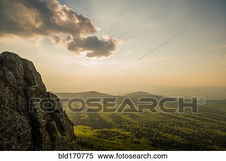 Stock Photography - Rocky hilltop over rural landscape. Fotosearch