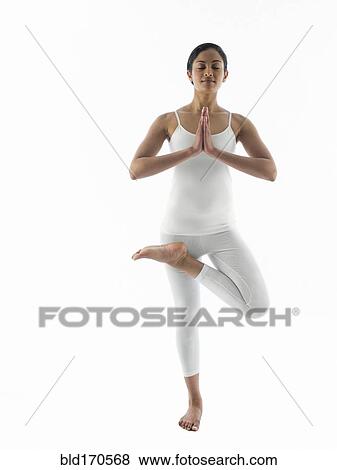 Stock Photo - Serene woman practicing yoga. Fotosearch