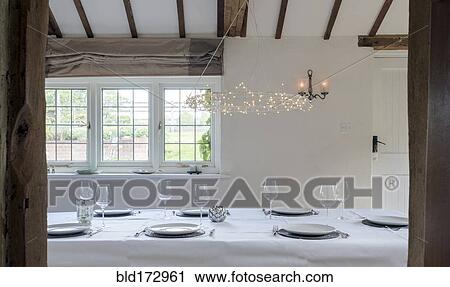 Stock Image - Set table in dining room. Fotosearch