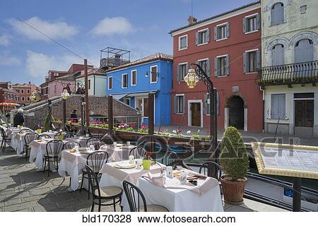 Sidewalk cafe overlooking Venice Burano canal, Veneto, Italy View Large Photo Image Stock Photo - Sidewalk cafe overlooking Venice Burano canal, Veneto, Italy. Fotosearch