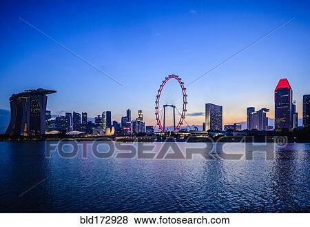 Stock Photo - Singapore city skyline under sunset sky, Singapore, Singapore. Fotosearch