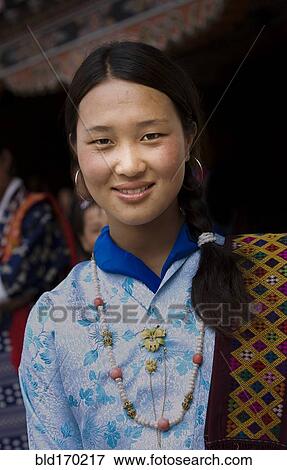 Smiling Asian girl wearing traditional clothing View Large Photo Image Stock Photo - Smiling Asian girl wearing traditional clothing. Fotosearch