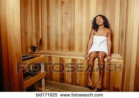 Stock Photography - Smiling woman relaxing in sauna. Fotosearch