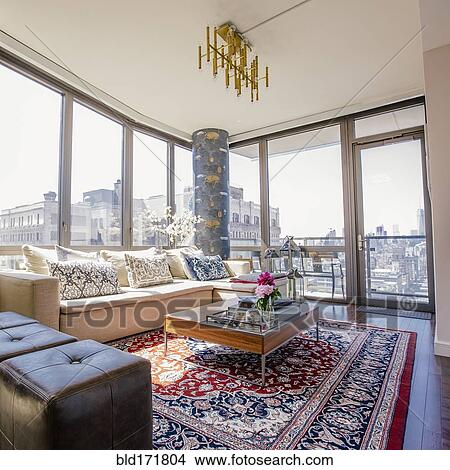 Sofa and rug in urban apartment living room View Large Photo Image Picture - Sofa and rug in urban apartment living room. Fotosearch
