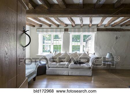 Stock Photo - Sofa under beams in living room. Fotosearch