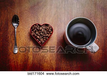 Picture - Spoon, beans and cup of coffee on counter. Fotosearch