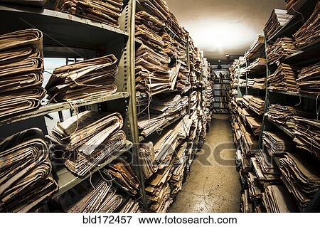 Stock Photo - Stacks of old newspapers in library archive. Fotosearch