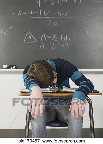 Student sleeping at desk in classroom View Large Photo Image Stock Photo - Student sleeping at desk in classroom. Fotosearch