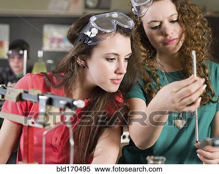 Stock Photography - Students examining sample in science lab classroom. Fotosearch