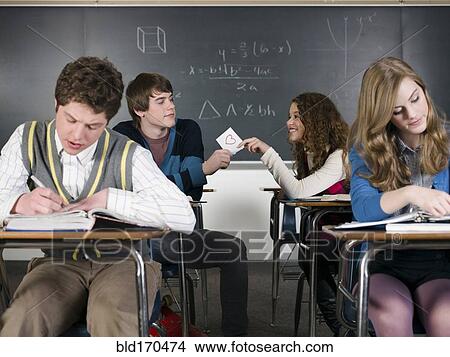 Students passing love note in classroom View Large Photo Image Picture - Students passing love note in classroom. Fotosearch
