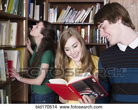 Picture - Students reading books in library. Fotosearch