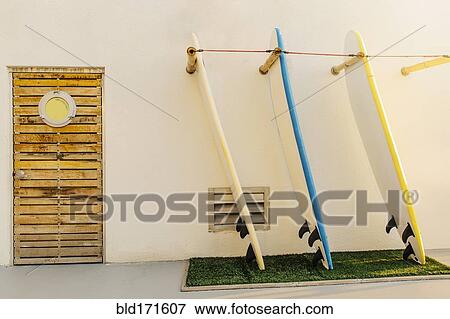 Stock Photo - Surfboards in rack on building exterior. Fotosearch