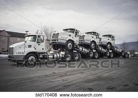 Truck towing truck engines on dirt road View Large Photo Image Stock Photo - Truck towing truck engines on dirt road. Fotosearch
