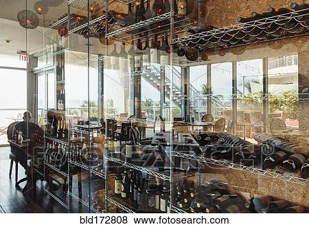 Wine bottles on shelves in restaurant View Large Photo Image Stock Photo - Wine bottles on shelves in restaurant. Fotosearch