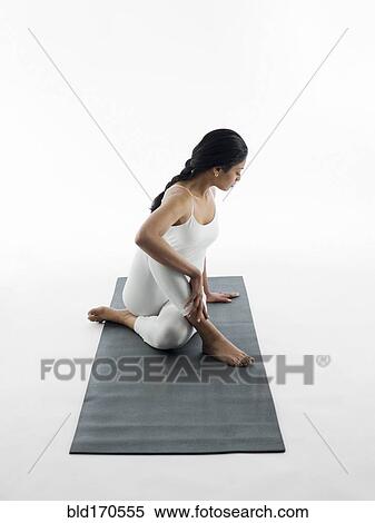 Woman practicing yoga on mat View Large Photo Image Stock Photography - Woman practicing yoga on mat. Fotosearch