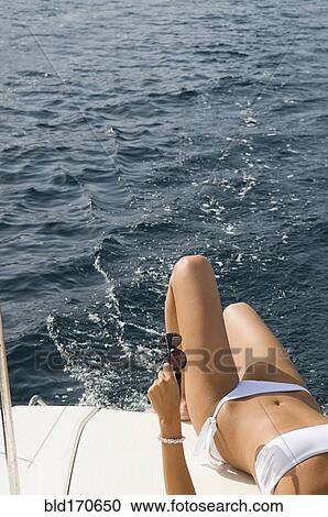 Woman wearing bikini on boat deck View Large Photo Image Stock Image - Woman wearing bikini on boat deck. Fotosearch