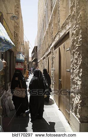 Women in hijab walking on Doha sidewalk, Doha, Qatar View Large Photo Image Stock Photo - Women in hijab walking on Doha sidewalk, Doha, Qatar. Fotosearch