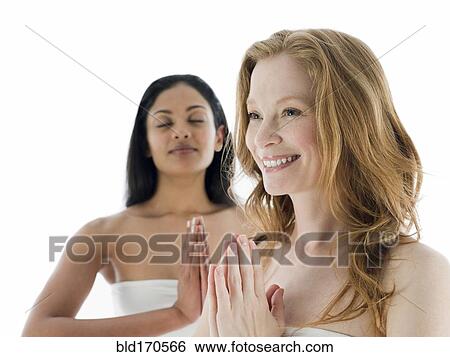 Women meditating with hands clasped View Large Photo Image Stock Photograph - Women meditating with hands clasped. Fotosearch
